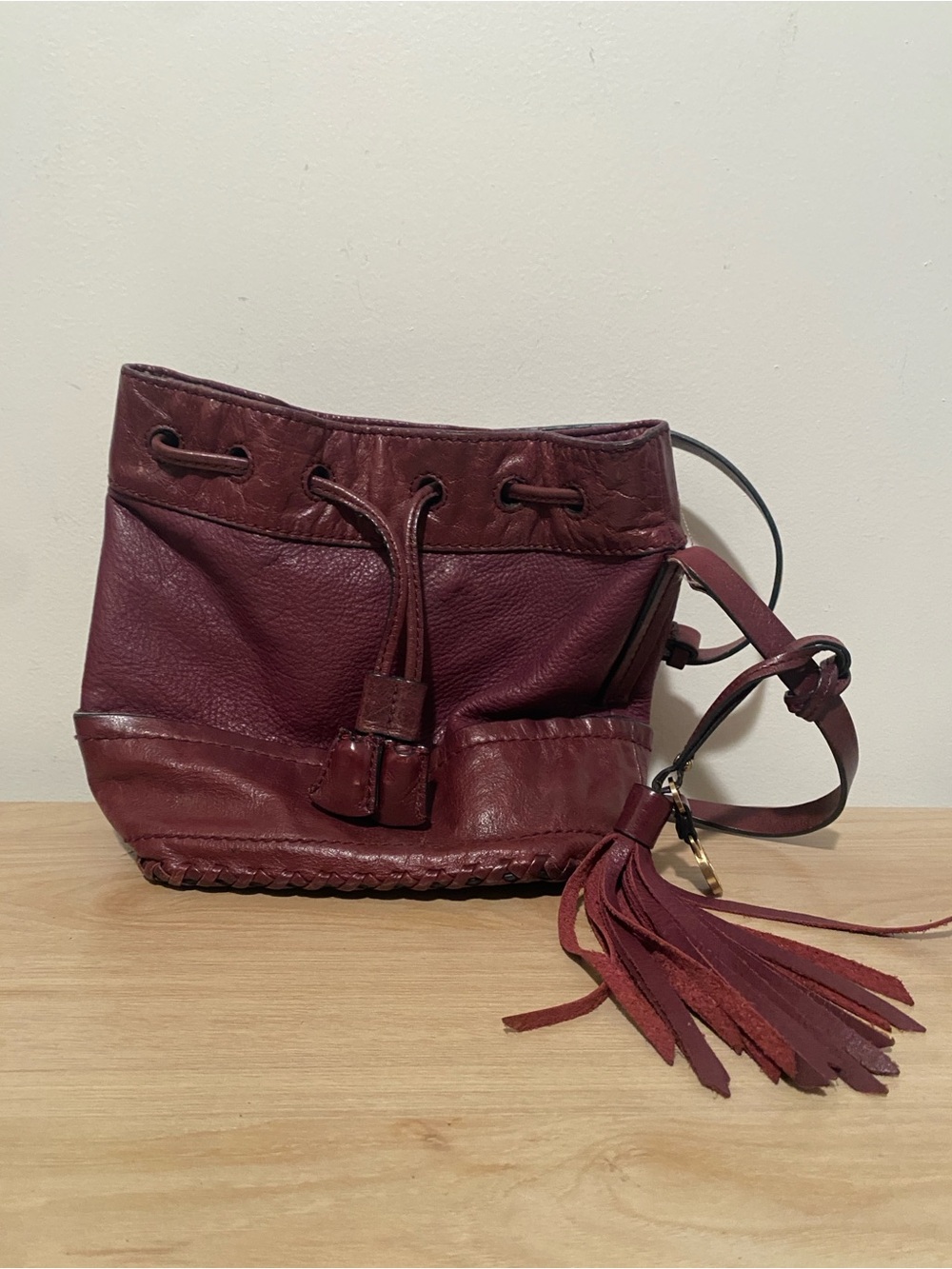 Isabella Fiore Burgundy Leather Drawstring Crossbody with Tassel